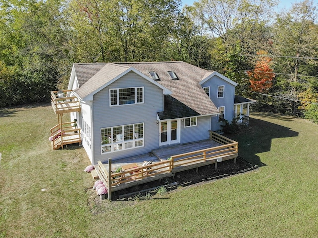 back of house with a wooden deck, stairs, a lawn, and roof with shingles