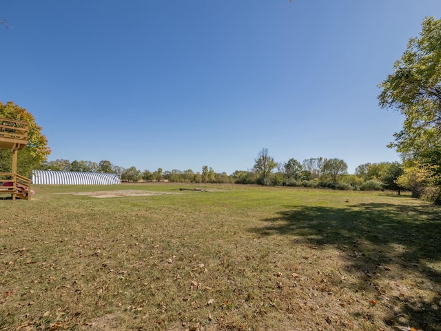 view of yard with a rural view and fence