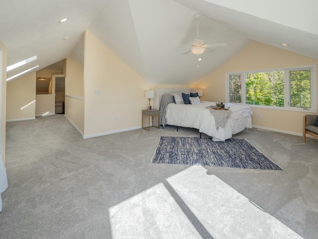 carpeted bedroom with ceiling fan, baseboards, and vaulted ceiling