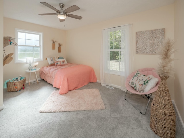 bedroom with carpet floors, multiple windows, and baseboards