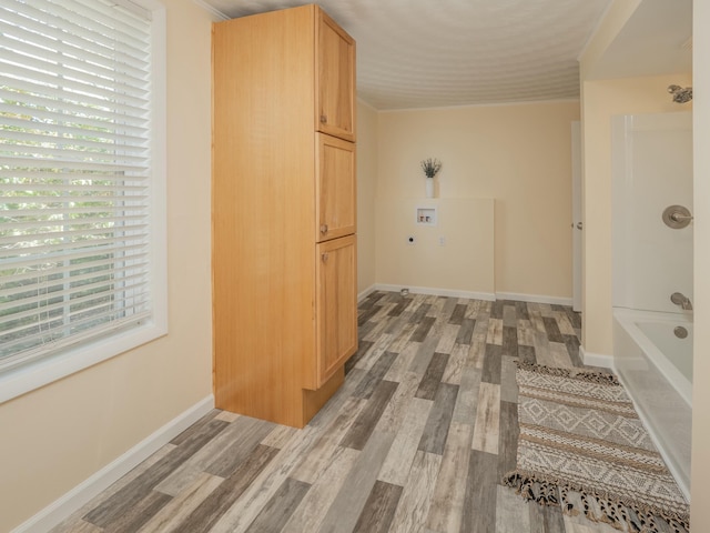 hallway with light wood finished floors and baseboards