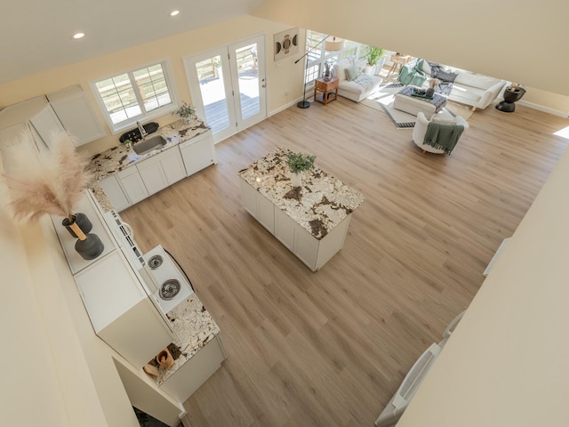 living area featuring recessed lighting, baseboards, and light wood finished floors