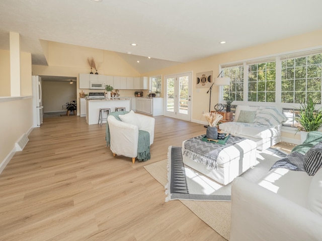 living room featuring lofted ceiling, recessed lighting, visible vents, light wood-style floors, and baseboards