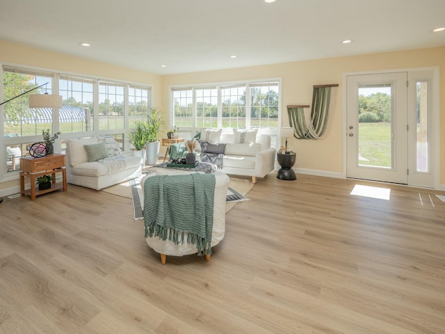 living area featuring recessed lighting, baseboards, and wood finished floors