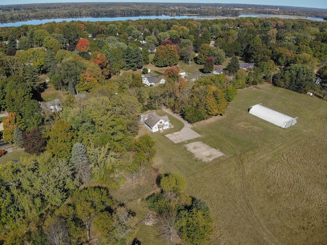 aerial view with a water view and a forest view