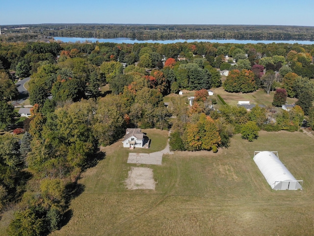 birds eye view of property featuring a water view and a forest view