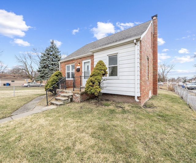 bungalow-style house with roof with shingles, a front lawn, a chimney, and fence