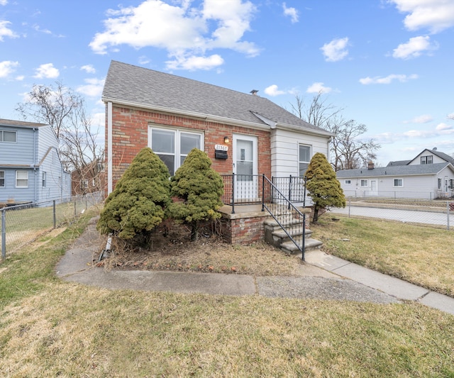 bungalow featuring a front yard, brick siding, fence, and roof with shingles