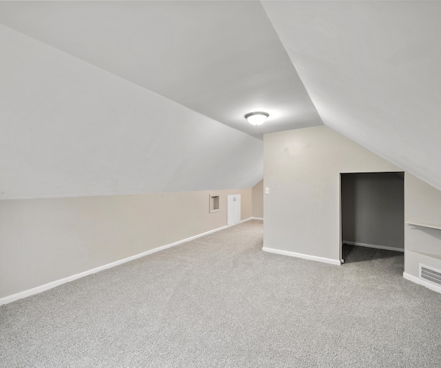 bonus room with vaulted ceiling, carpet, and baseboards