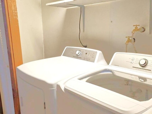 clothes washing area with laundry area and washer and clothes dryer