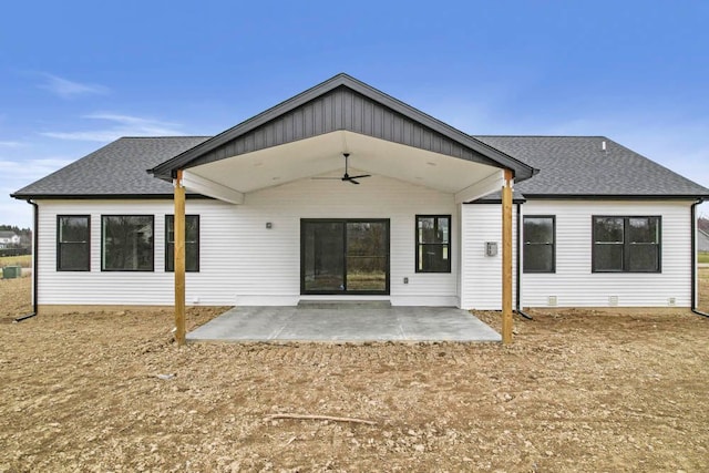 back of house featuring a patio and roof with shingles