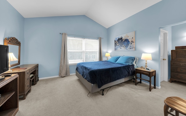 bedroom with lofted ceiling, light colored carpet, and baseboards