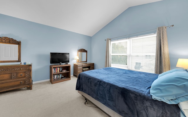 carpeted bedroom featuring baseboards and vaulted ceiling