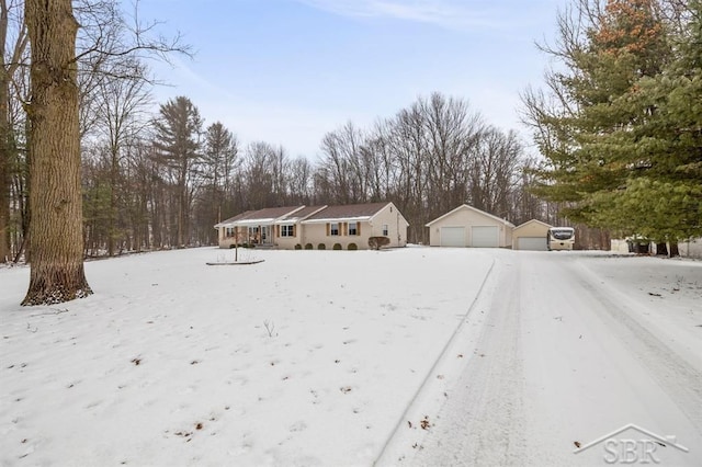 view of front of home with a garage and an outdoor structure