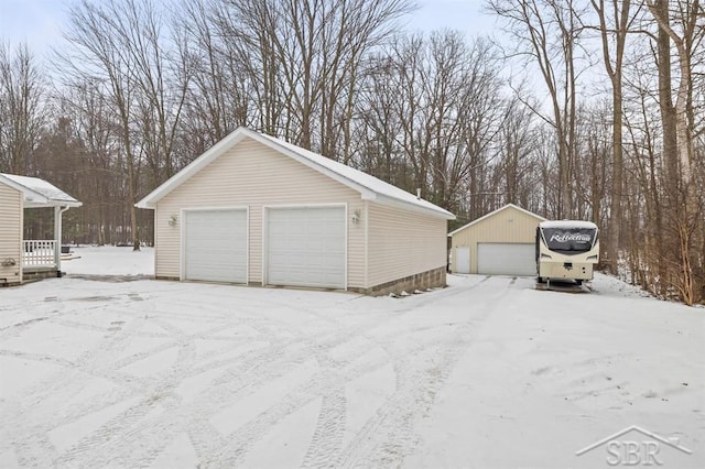 snow covered garage featuring a garage