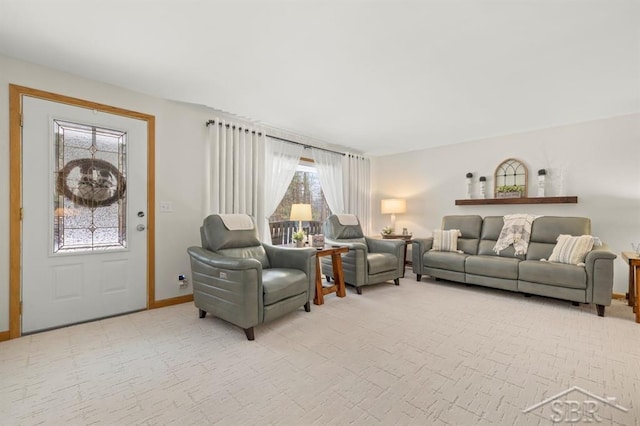 living area featuring light carpet and baseboards