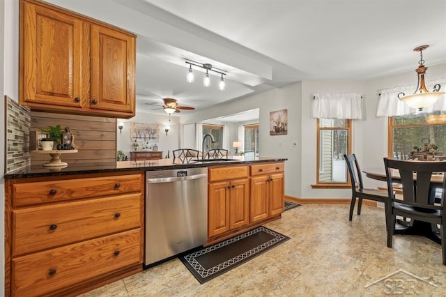 kitchen with brown cabinetry, dishwasher, hanging light fixtures, and a sink