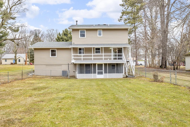 back of house featuring a sunroom, a fenced backyard, stairway, and a lawn