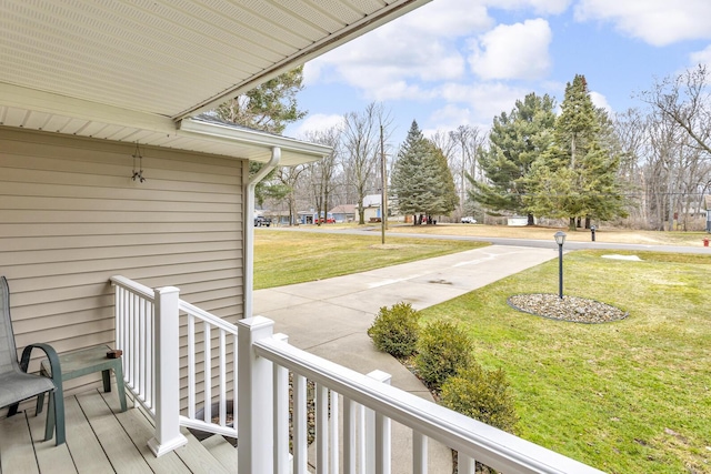 wooden deck with a lawn