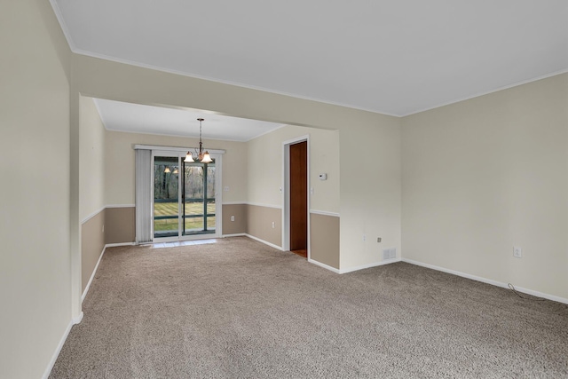 unfurnished room with crown molding, carpet, a notable chandelier, and baseboards