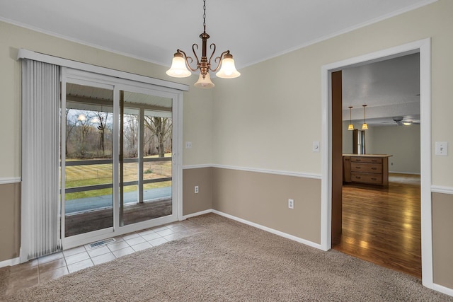 spare room with ornamental molding, carpet flooring, visible vents, and baseboards