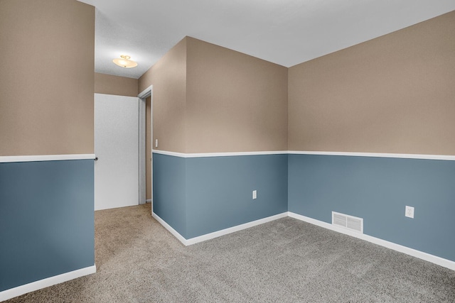 carpeted empty room with baseboards and visible vents