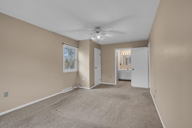 unfurnished bedroom featuring carpet flooring, connected bathroom, and baseboards