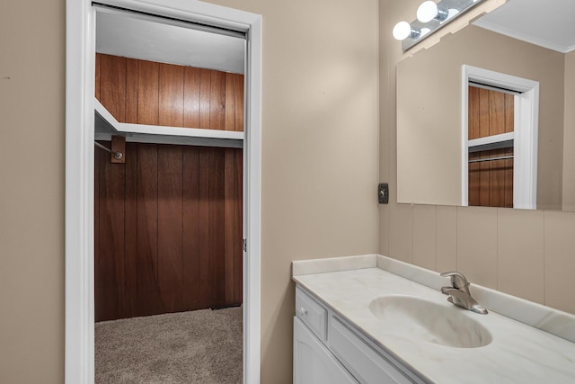 bathroom with ornamental molding and vanity