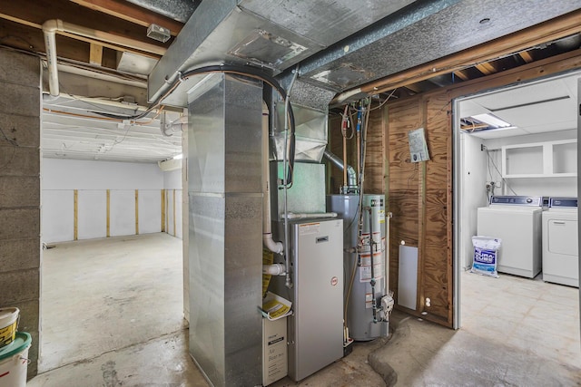 utilities featuring heating unit, washer and clothes dryer, and gas water heater