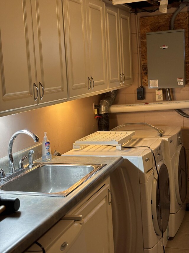 laundry area featuring independent washer and dryer, cabinet space, and a sink