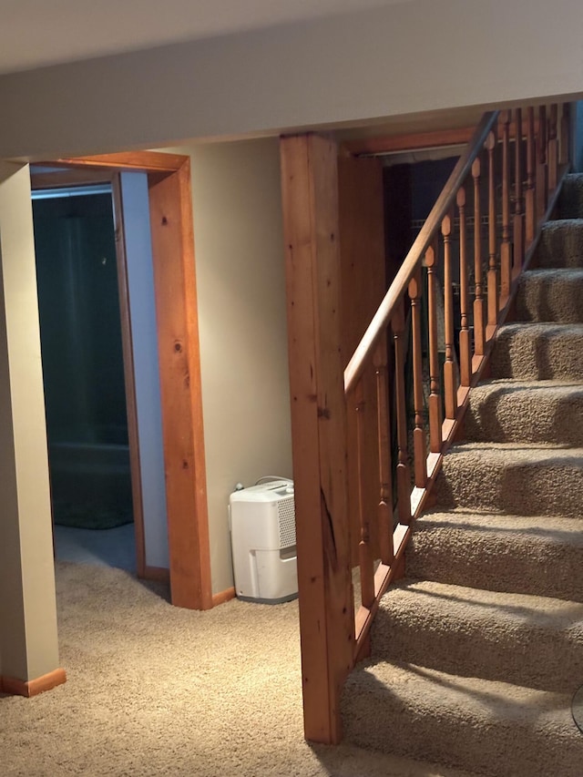 finished basement with stairs, carpet flooring, and baseboards