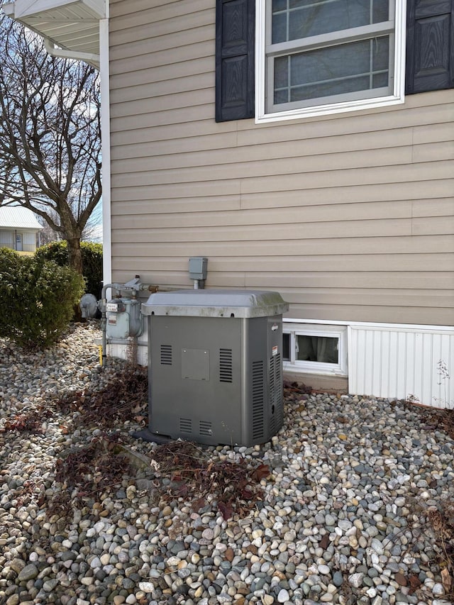 exterior details featuring gas meter, crawl space, and a power unit