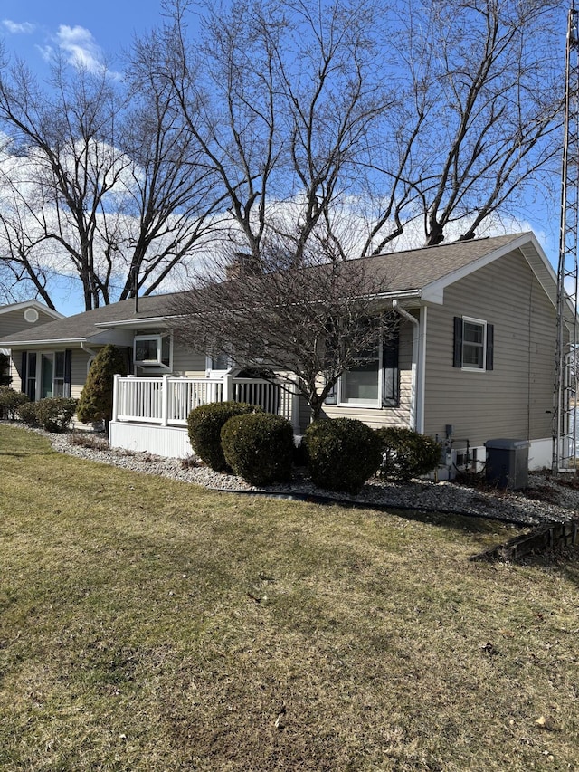 ranch-style home featuring central AC and a front yard