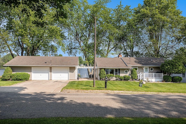 222 Crockett Dr, Quincy, MI 49082 - view of front of home featuring concrete driveway, a front yard, an attached garage, and a chimney