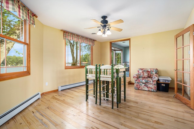 222 Crockett Dr, Quincy, MI 49082 - dining space featuring a baseboard radiator, hardwood / wood-style floors, and ceiling fan