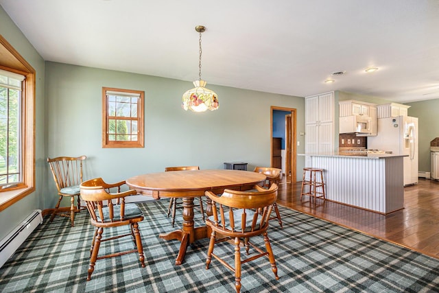 222 Crockett Dr, Quincy, MI 49082 - dining area featuring a baseboard heating unit and dark wood finished floors