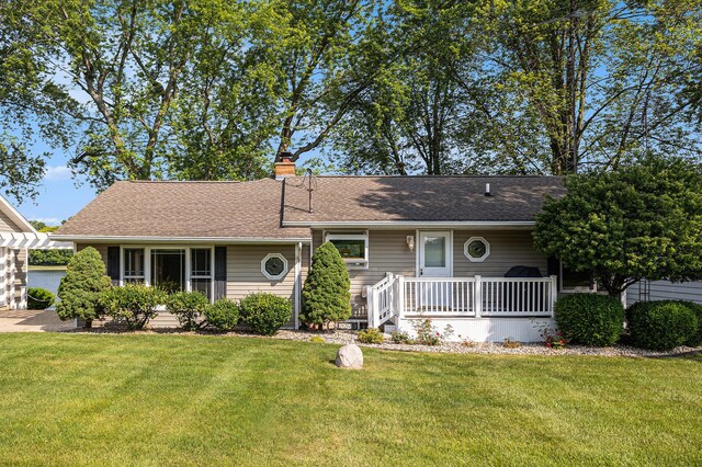 222 Crockett Dr, Quincy, MI 49082 - ranch-style house with a front yard, a chimney, a shingled roof, and a porch