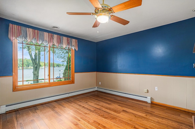 222 Crockett Dr, Quincy, MI 49082 - spare room with a wainscoted wall, healthy amount of natural light, hardwood / wood-style flooring, a water view, and ceiling fan