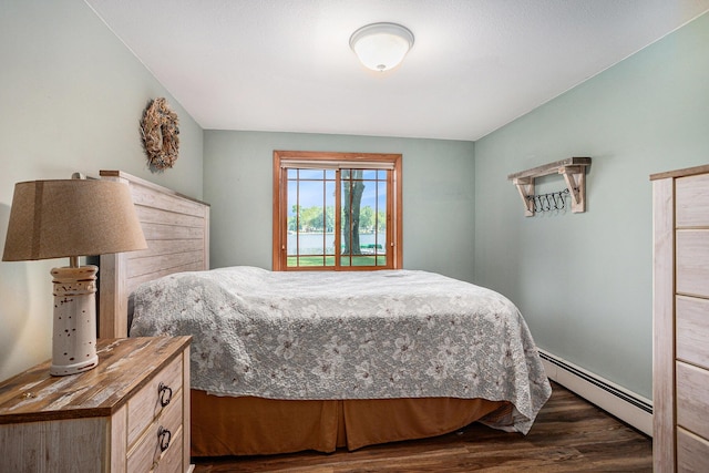222 Crockett Dr, Quincy, MI 49082 - bedroom with a baseboard heating unit and dark wood-style floors