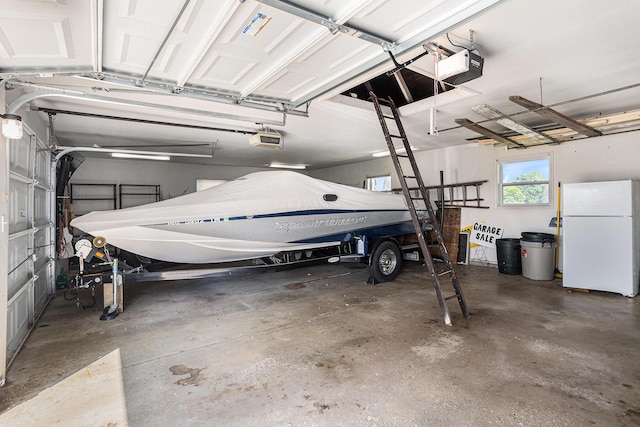 222 Crockett Dr, Quincy, MI 49082 - garage with freestanding refrigerator and a garage door opener