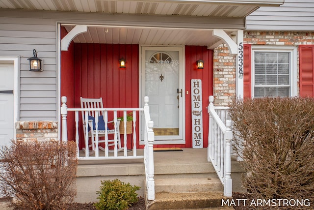 property entrance featuring brick siding