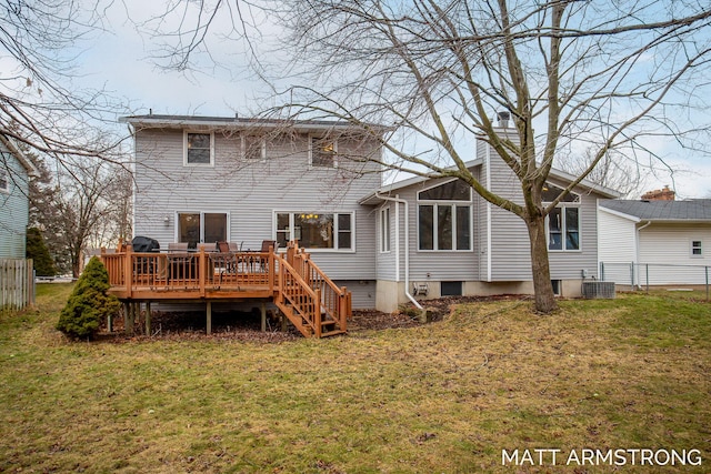 back of house with a chimney, a lawn, and a wooden deck