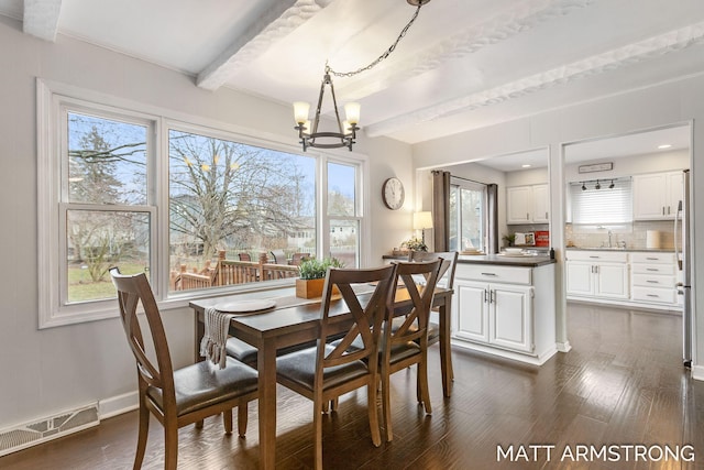 dining area with a chandelier, visible vents, baseboards, dark wood-style floors, and beamed ceiling