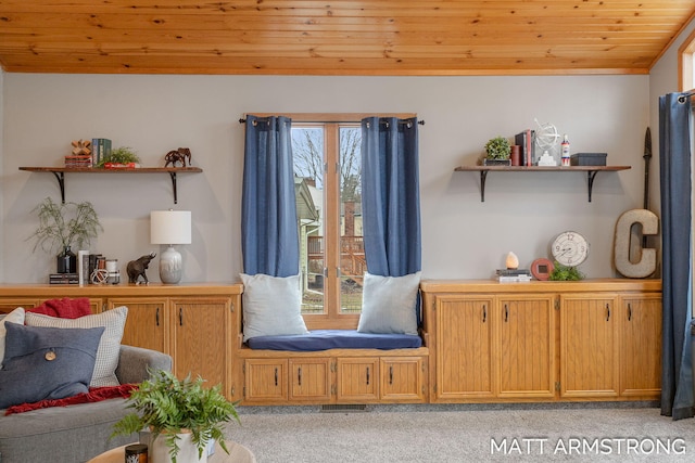 sitting room featuring a wealth of natural light, wooden ceiling, light colored carpet, and lofted ceiling