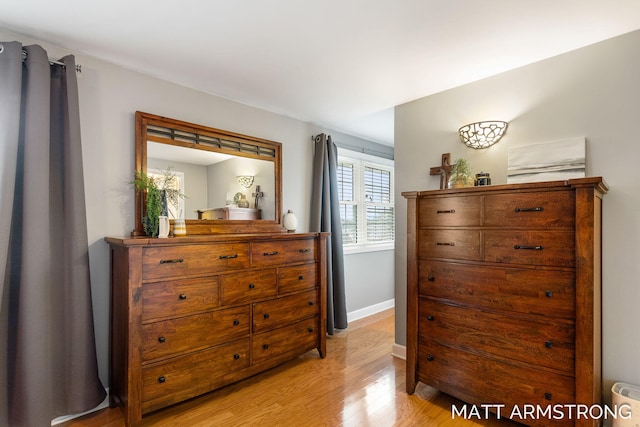 bedroom with baseboards and light wood finished floors