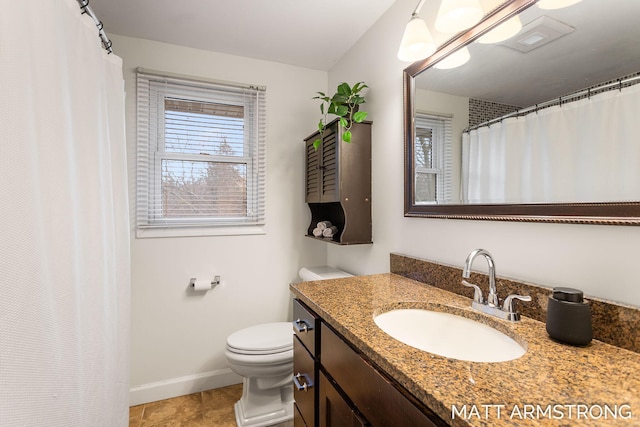 bathroom with visible vents, toilet, vanity, baseboards, and tile patterned floors