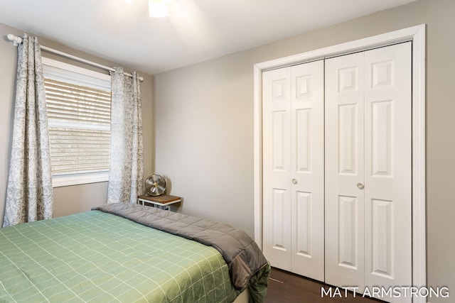 bedroom featuring a closet and dark wood finished floors