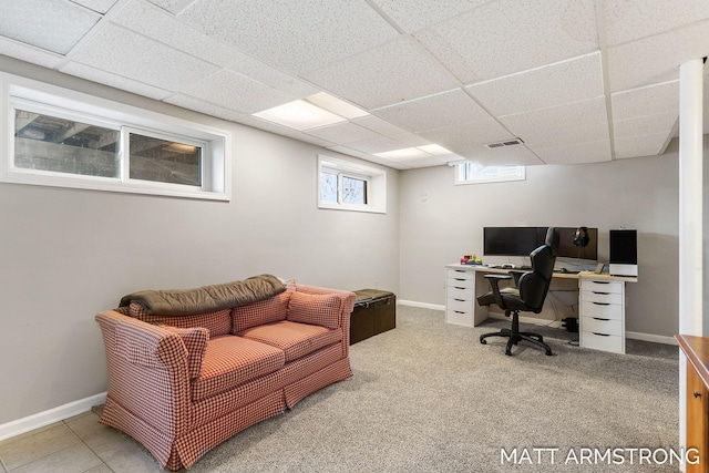 tiled office space with a paneled ceiling, carpet, visible vents, and baseboards