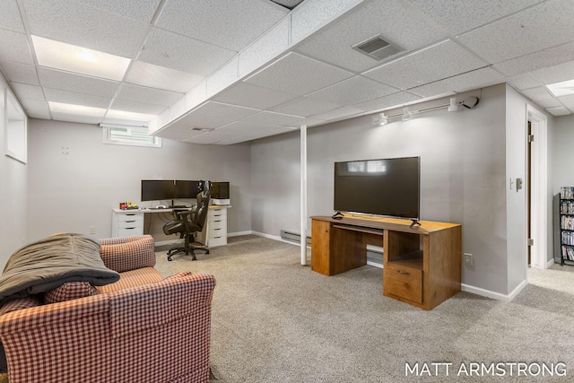 carpeted office featuring a paneled ceiling, a baseboard heating unit, baseboards, and visible vents