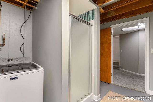 laundry room featuring laundry area, washer / clothes dryer, and baseboards